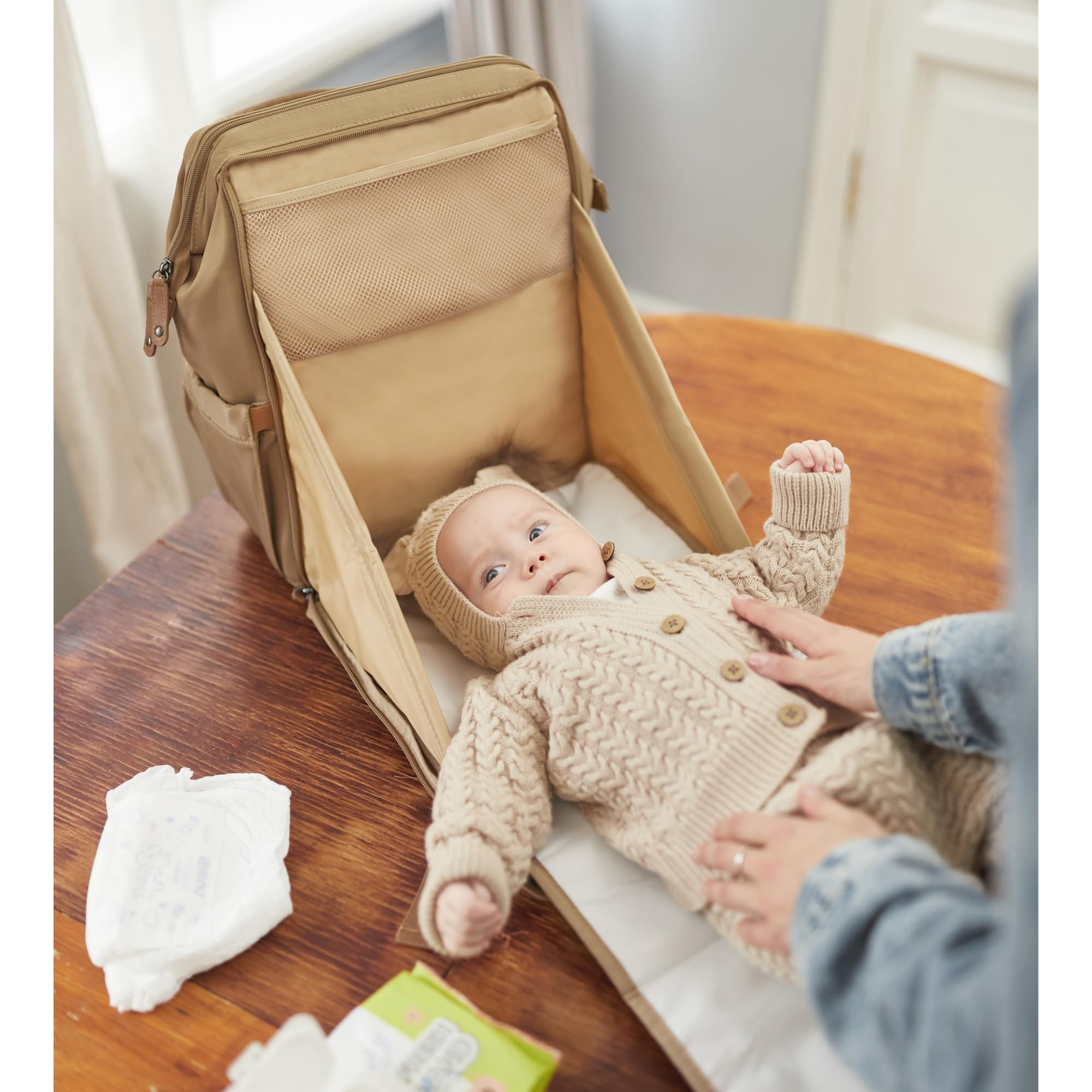 AIITA changing station bag demonstrates built-in changing pad for quick baby care.
