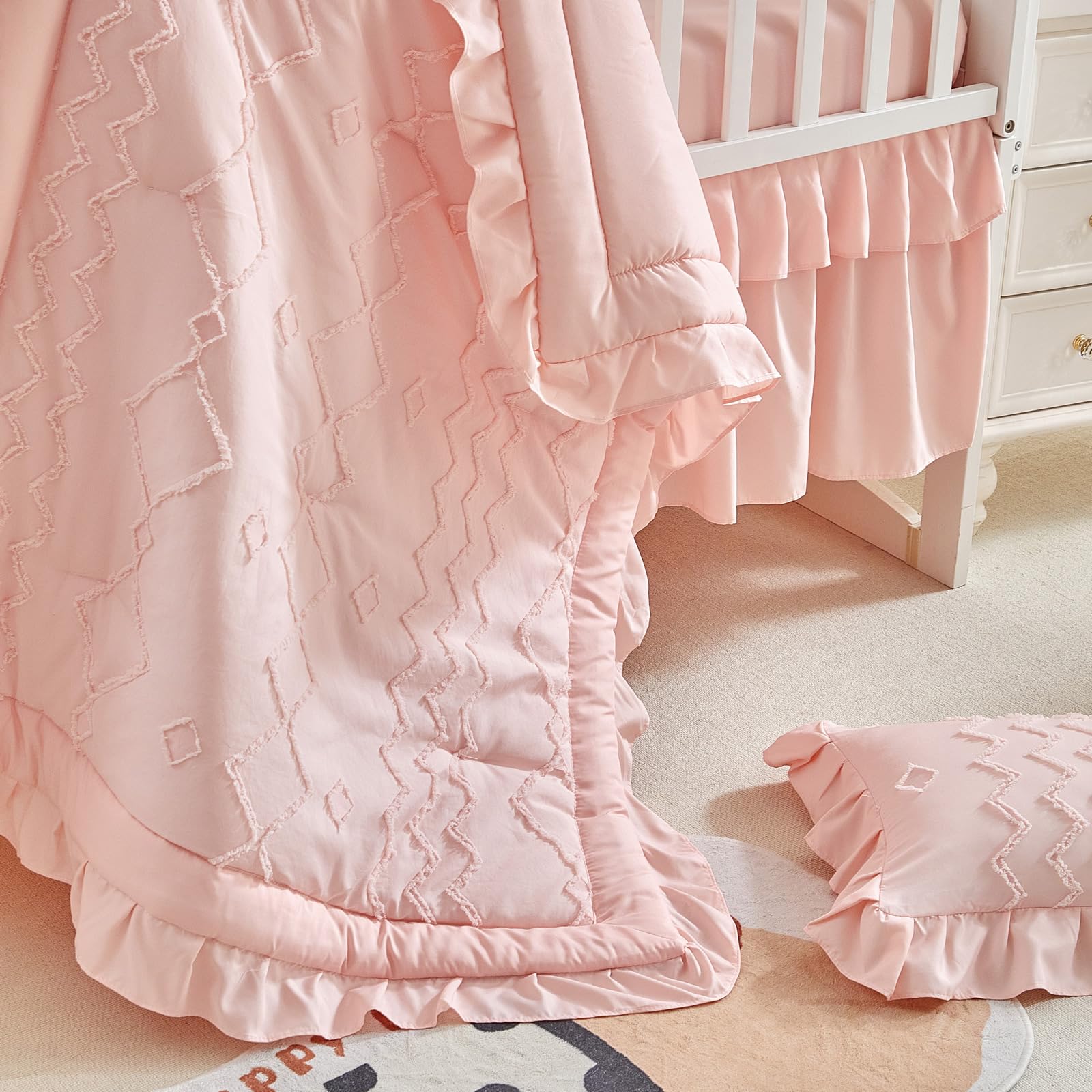 AIKASY nursery setup with crib bedding showcases cohesive coral pink theme.