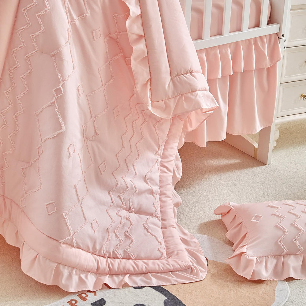 AIKASY nursery setup with crib bedding showcases cohesive coral pink theme.