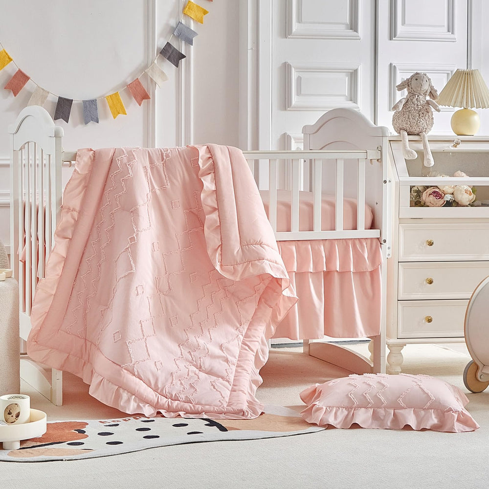 AIKASY ruffled crib comforter in coral pink offers cozy warmth and stylish charm.