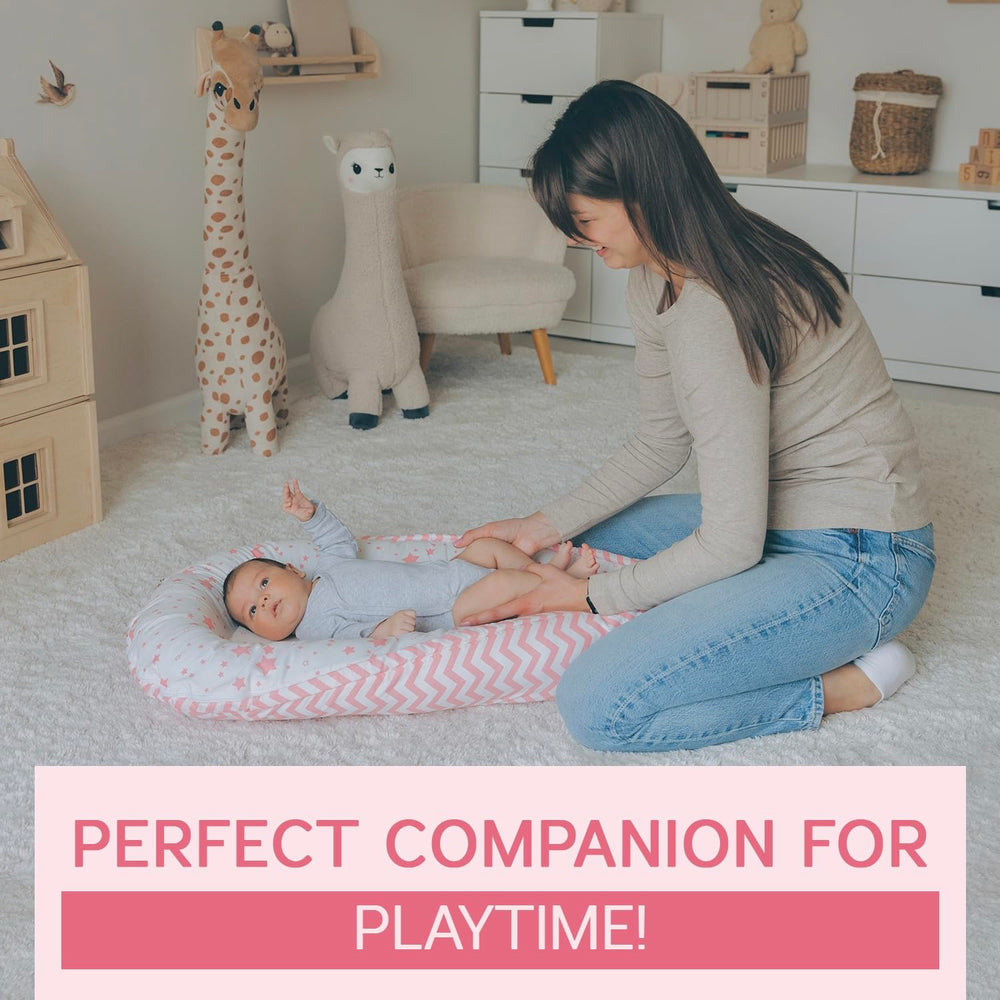 Compact, supervised-use infant lounger in pink for tummy time