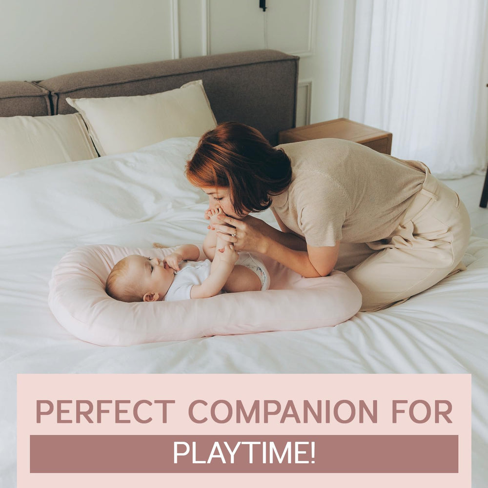 Aila + Aiden pink lounger in tummy-time setup with breathable surface for baby activity.