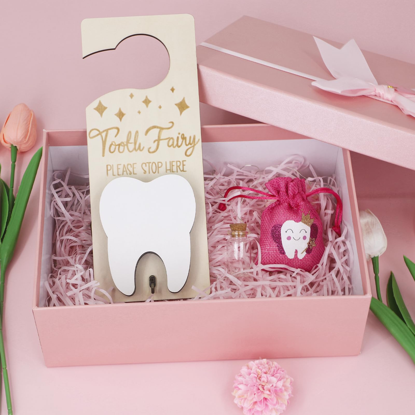 AINBIN glass keepsake bottle holds a tooth, marking a milestone with gentle clarity