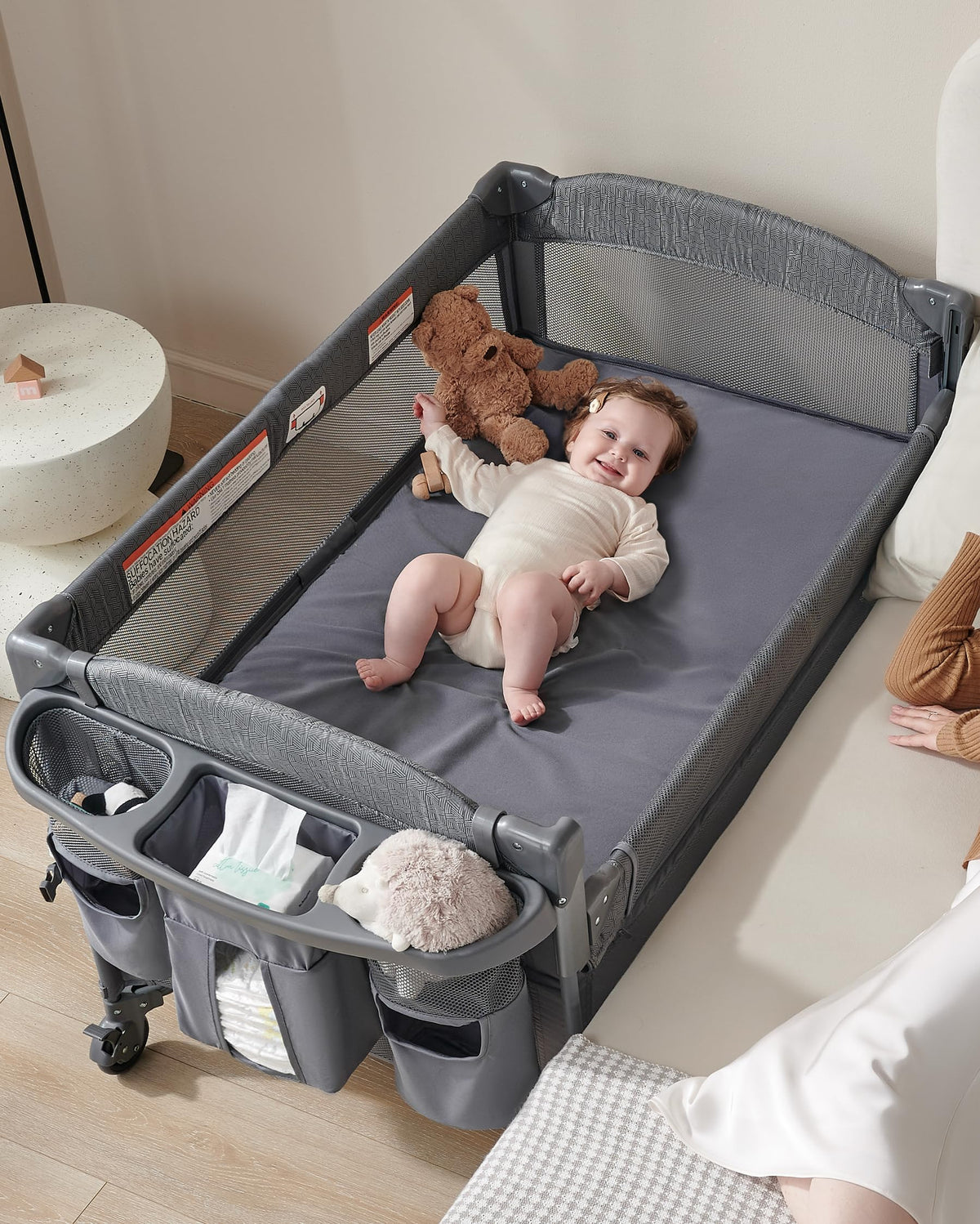 AirClub 4-in-1 bedside sleeper with retractable side for easy night-time access.