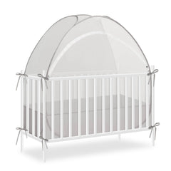 Akiky crib tent over a crib, fully opened for quick setup.