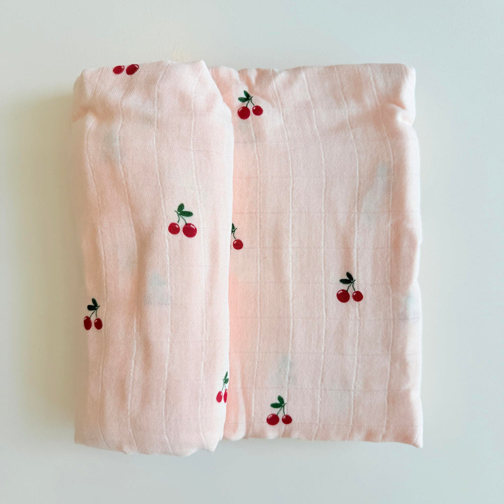 Ali+Oli baby cherry swaddle shown as car seat cover and nursing wrap.