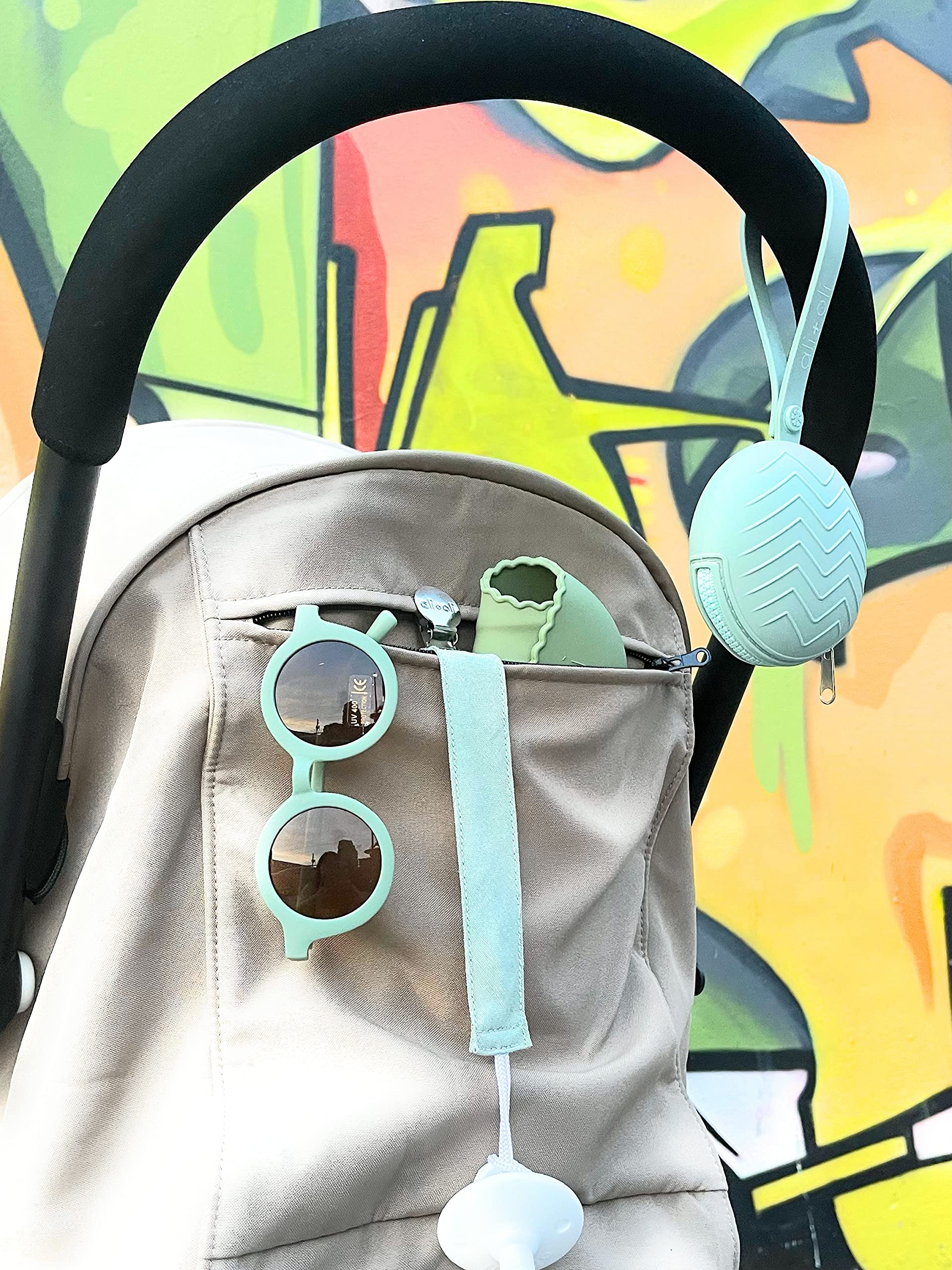 Ali+Oli hanging strap clips to stroller or car seat.