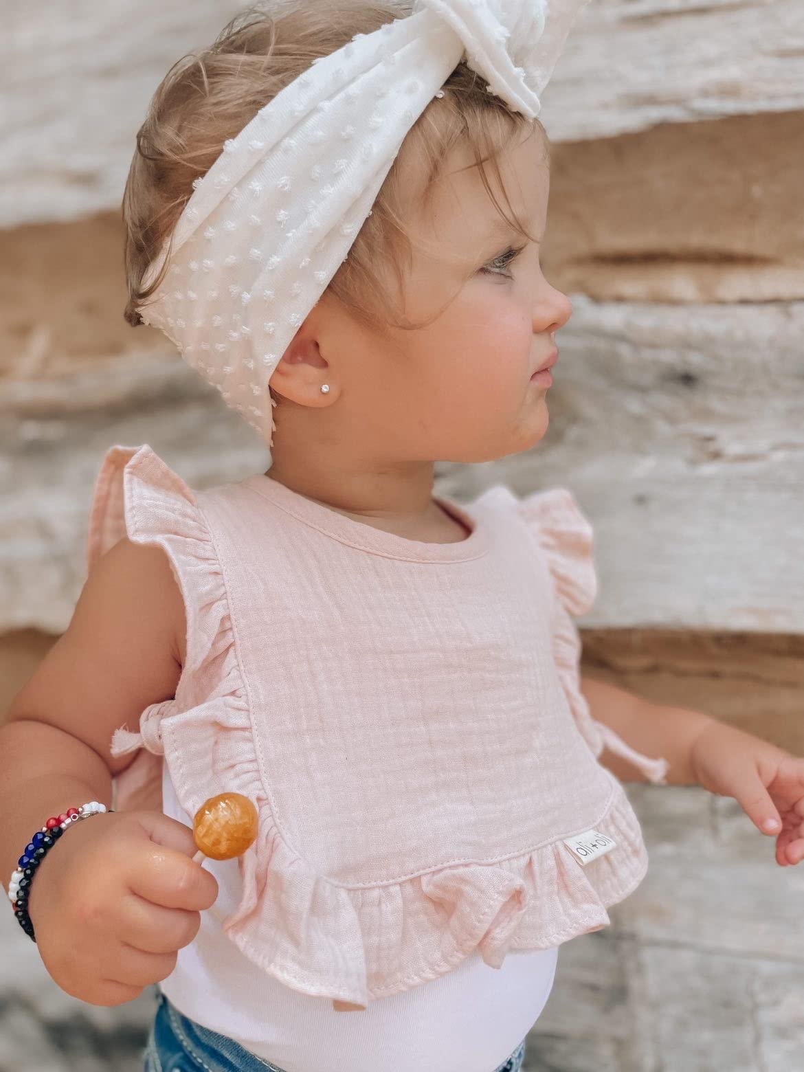 Ali+Oli Muslin Baby Bib keeps outfits clean during messy meals.