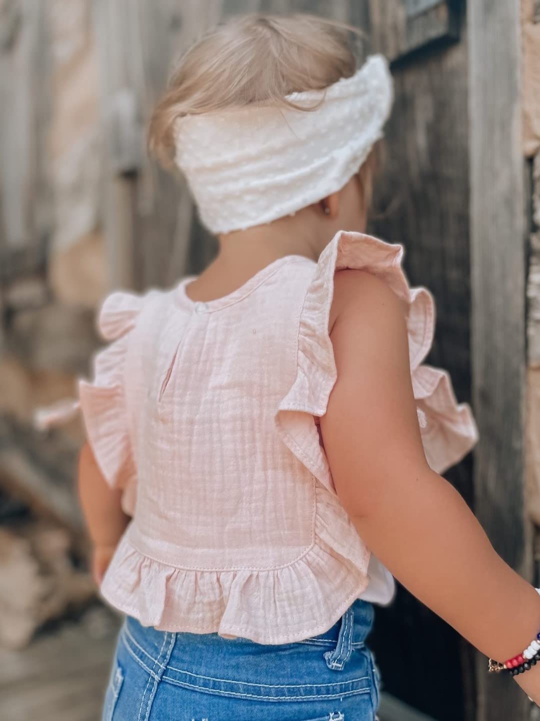 Ali+Oli Muslin Baby Bib offers a stylish ruffled detail for photos.