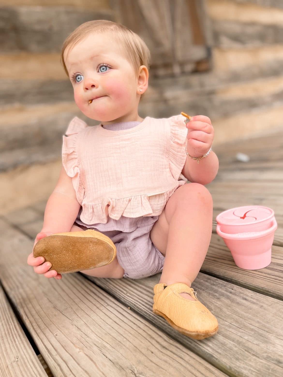 Ali+Oli Muslin Baby Bib with Snap Closure demonstrates snug fit for ages 0–24 months.