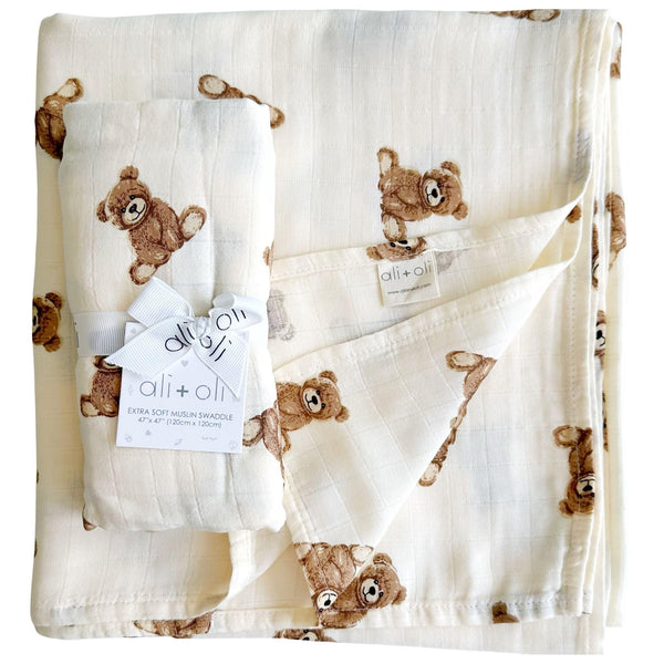 Ali+Oli swaddle blanket with teddy bear design, soft and breathable.