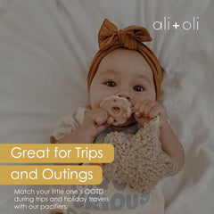 Ali+Oli silicone pacifier with a breathable shield.