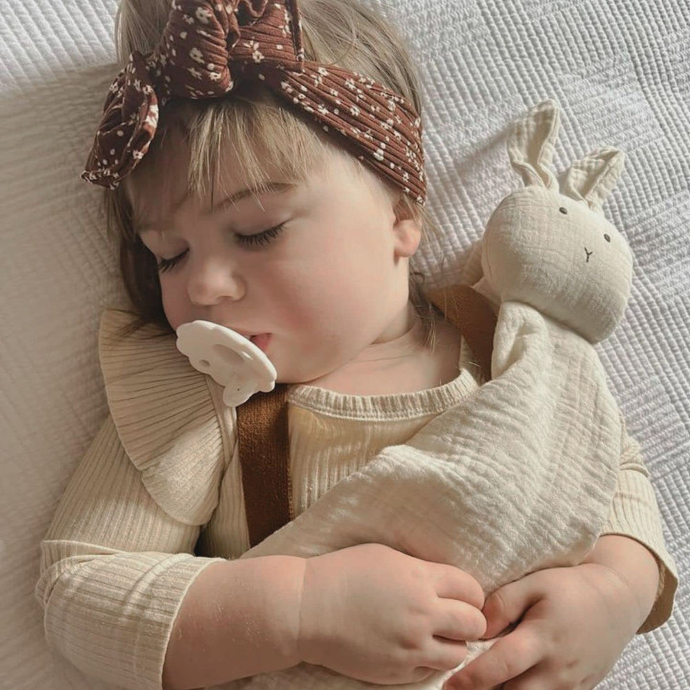 Ali+Oli rounded pacifier in pink-white for newborn comfort.