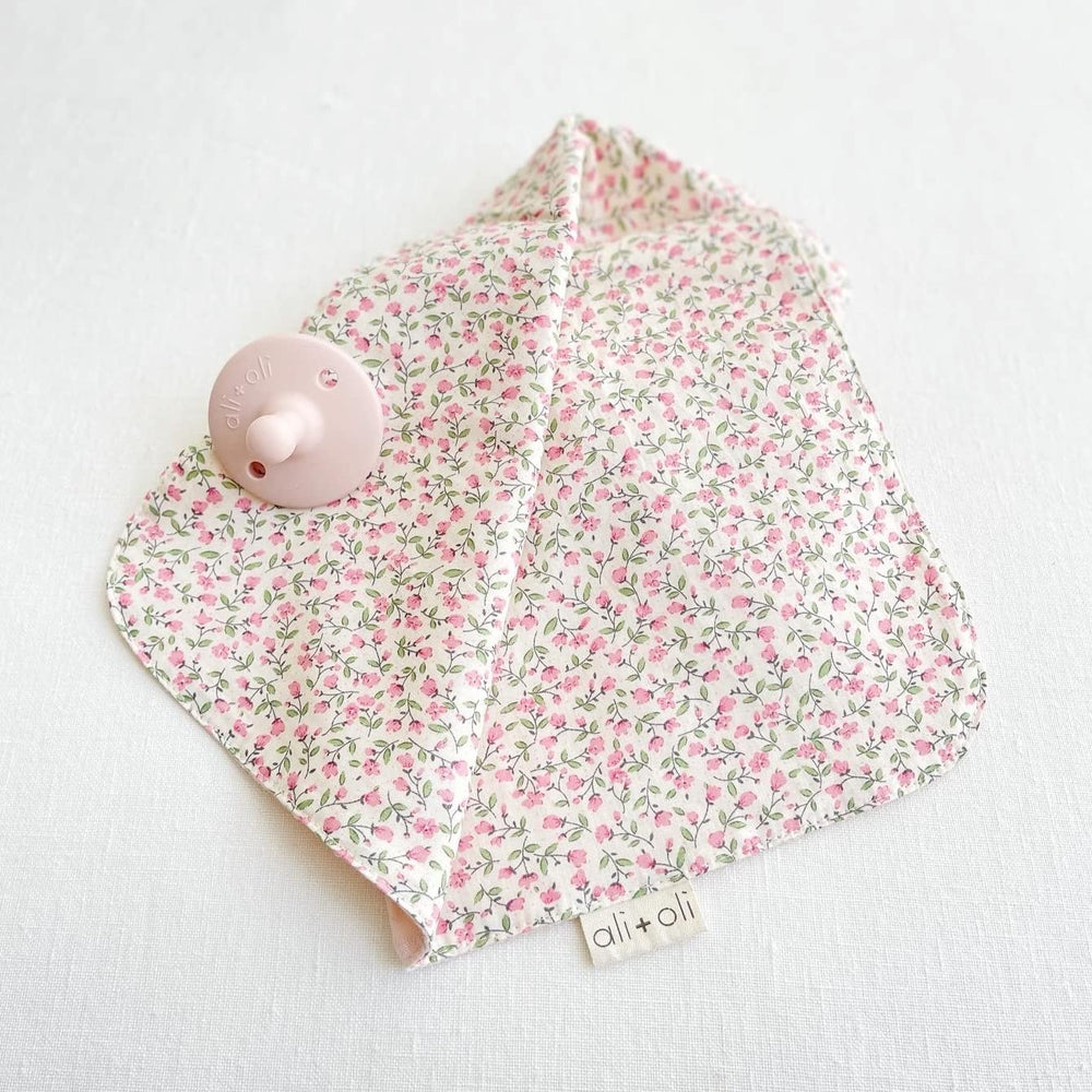 Ali+Oli cuddle blanket in pink flowers adds gentle texture and comforting look.
