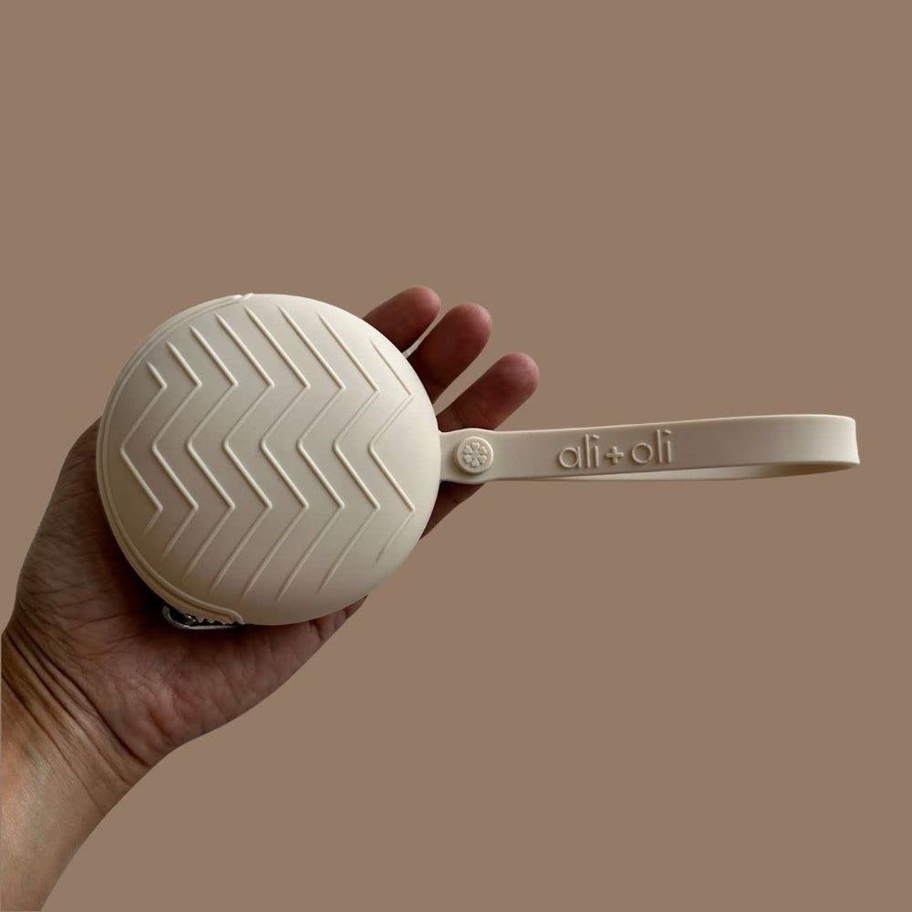 Ali+Oli silicone pacifier case modern neutral design complements any diaper bag.