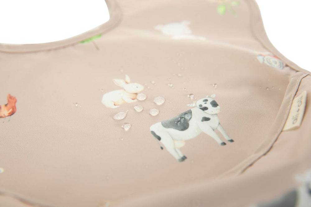 Ali+Oli Smock Bib, easy-clean surface for quick wipe-downs after meals.