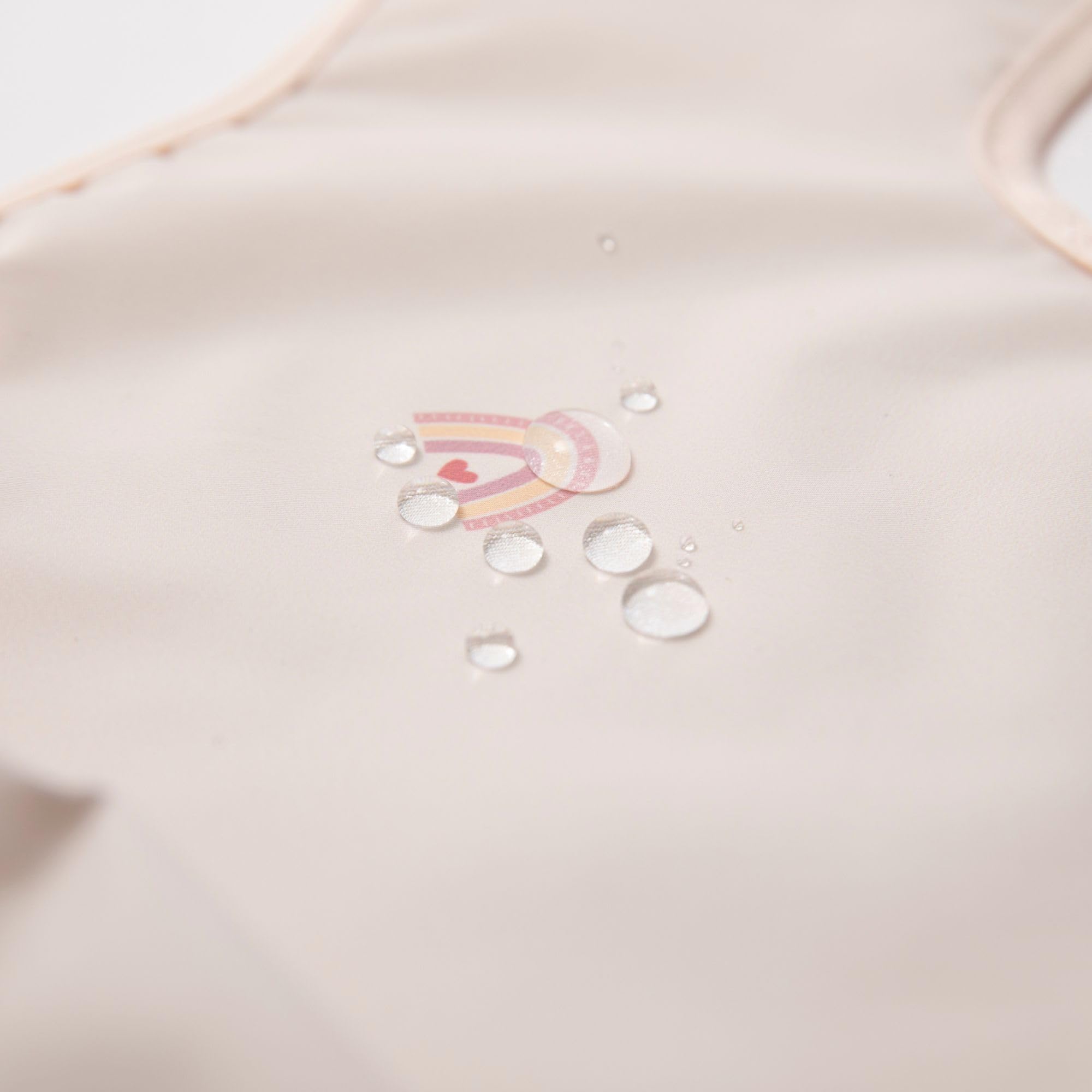 Ali+Oli Smock Bib close-up neck trim reveals soft, skin-friendly design.