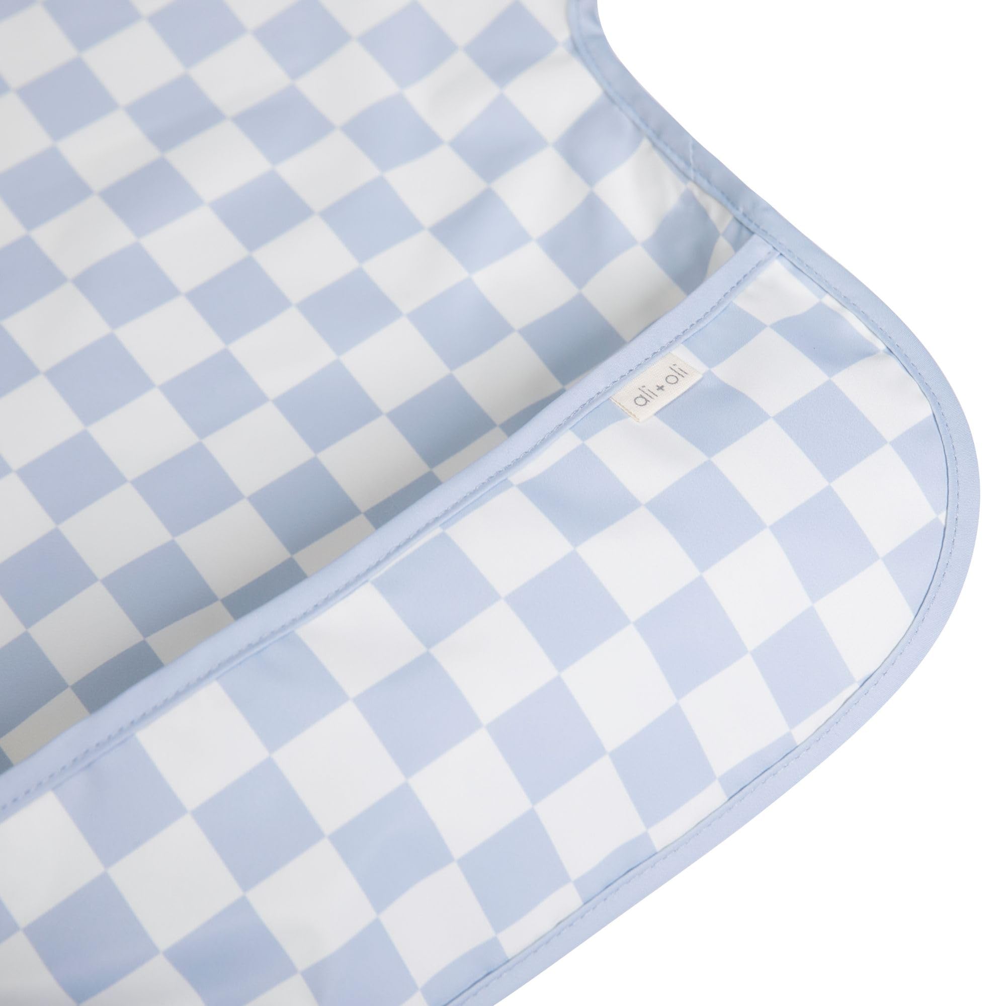Ali+Oli blue checkers smock bib back view showing sleeve coverage.