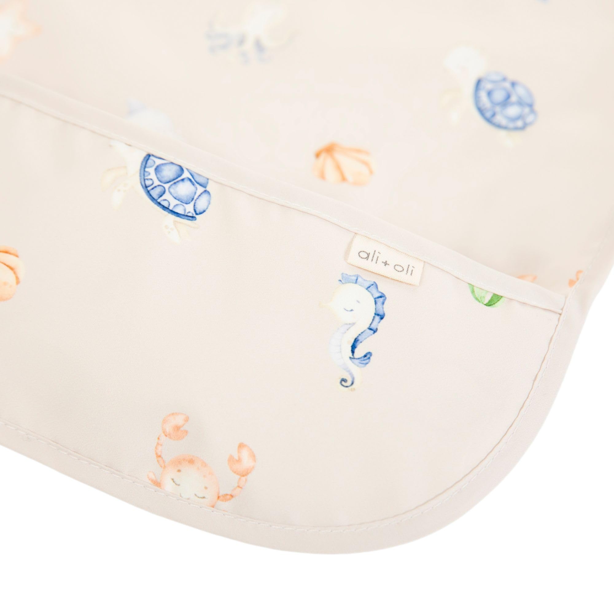 Ali+Oli long-sleeve smock bib shown in action during feeding