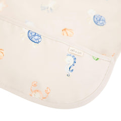 Ali+Oli long-sleeve smock bib shown in action during feeding
