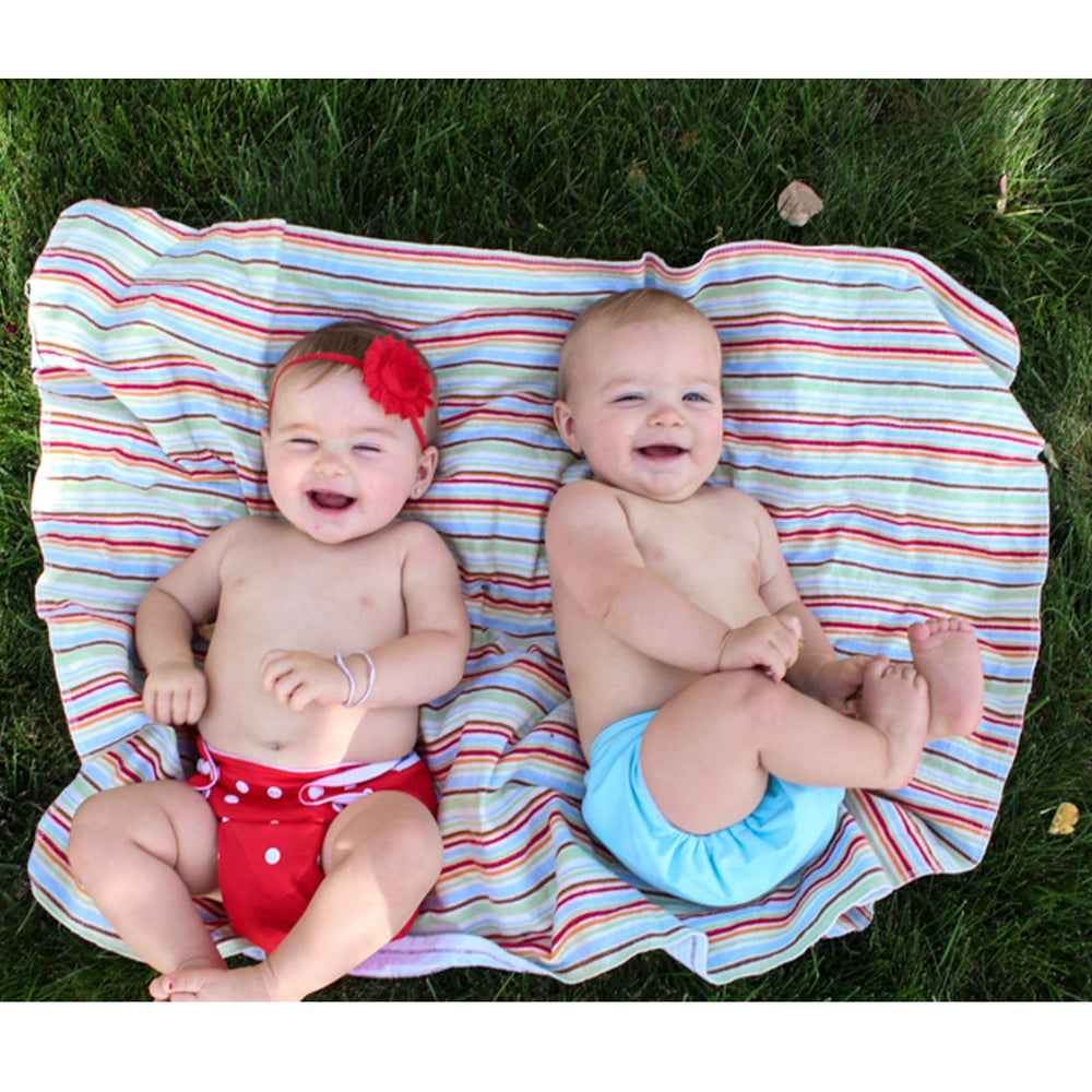 ALVA BABY hip/crossover snaps—prevents wing droop for secure fit.