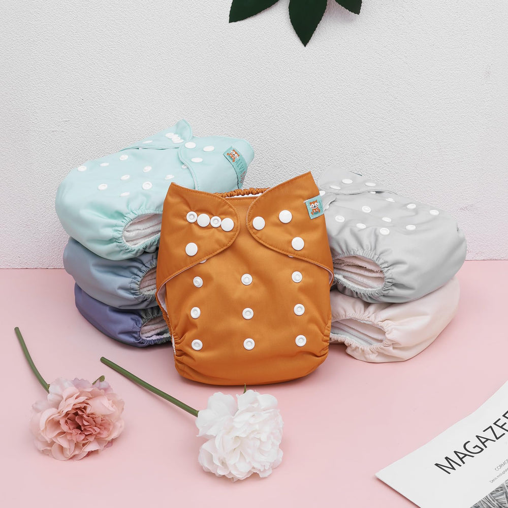 ALVABABY one-size diaper with hip and crossover snaps for growth.