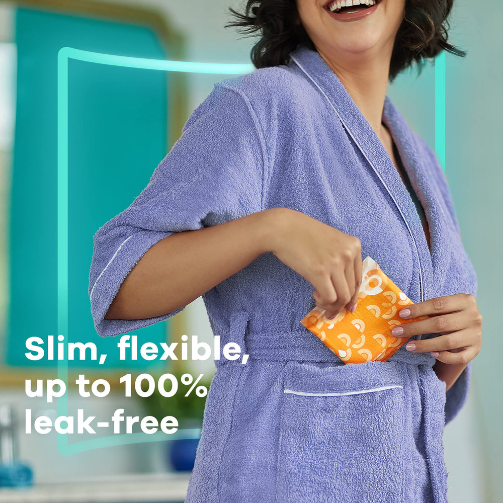 Always Ultra Thin overnight pad with wings rests on soft fabric surface.