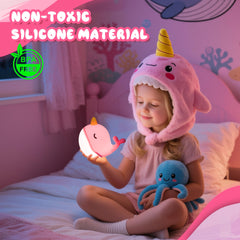 Ammonite Pink Narwhal Night Light emitting a gentle glow for nursery ambiance