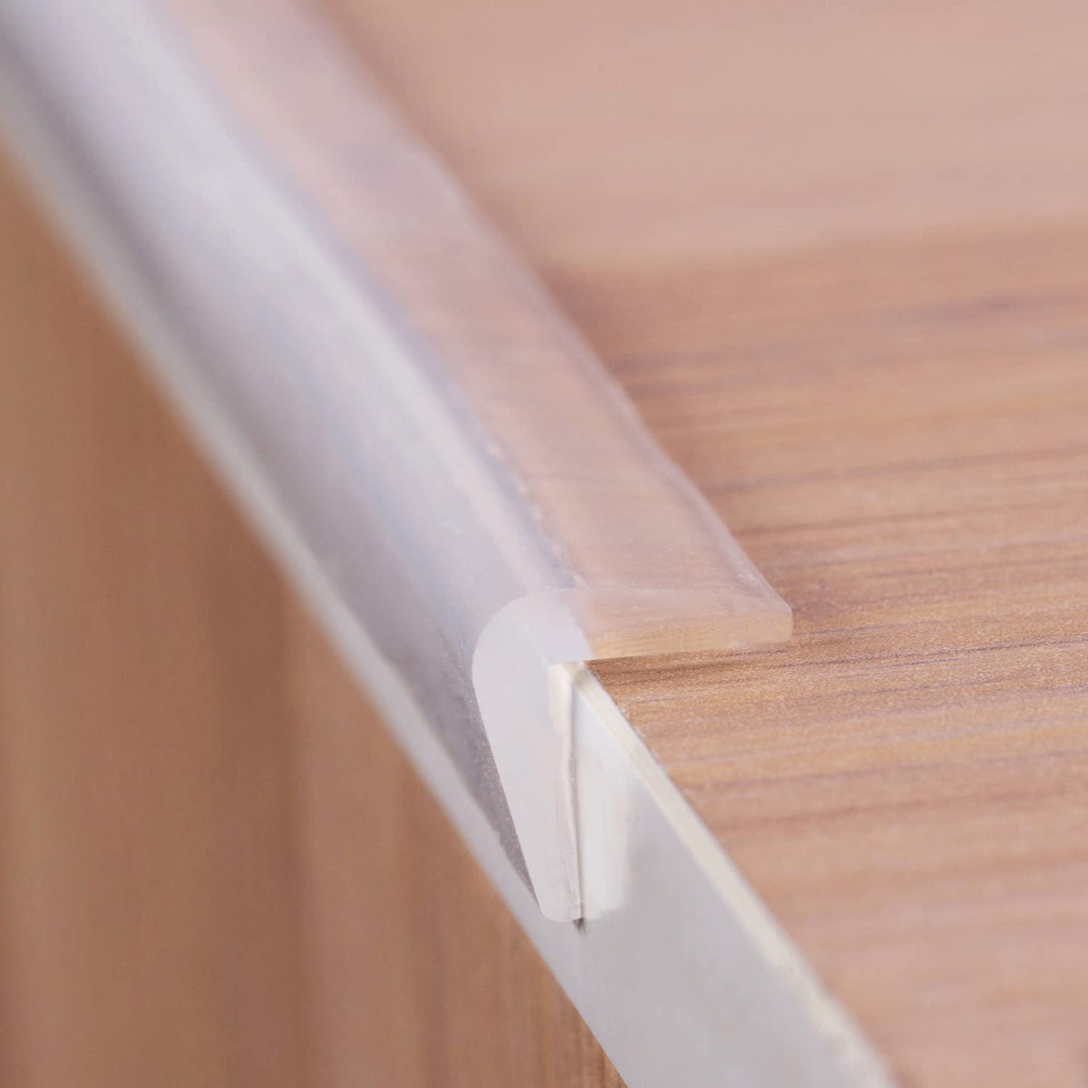 Angloria edge protector in clear silicone guards a corner with near-invisible safety.