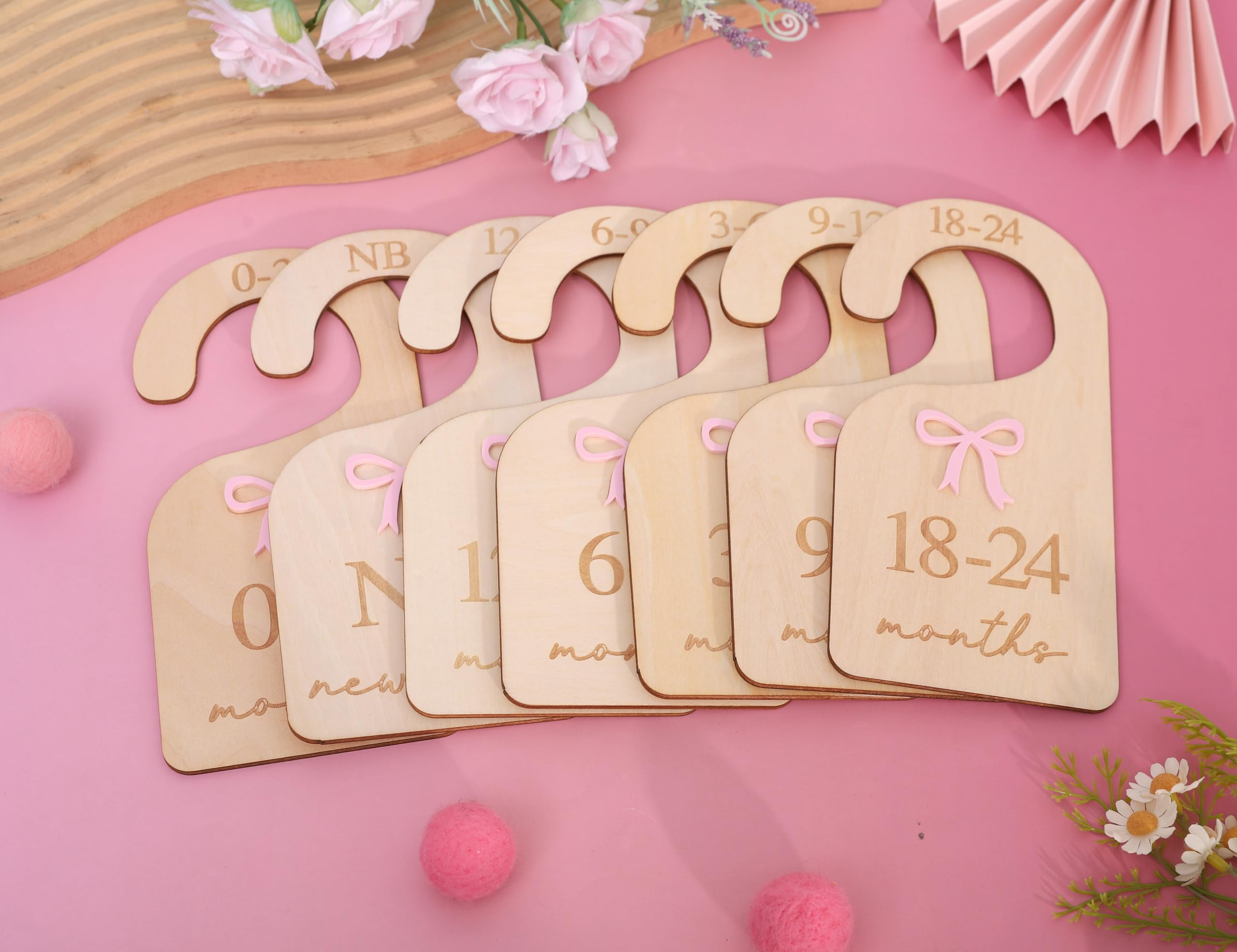 AOQURE girl wardrobe organizer using wooden dividers for easy size sorting.