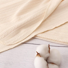 AQOKKA soft fabric close-up showing breathable texture for delicate skin.