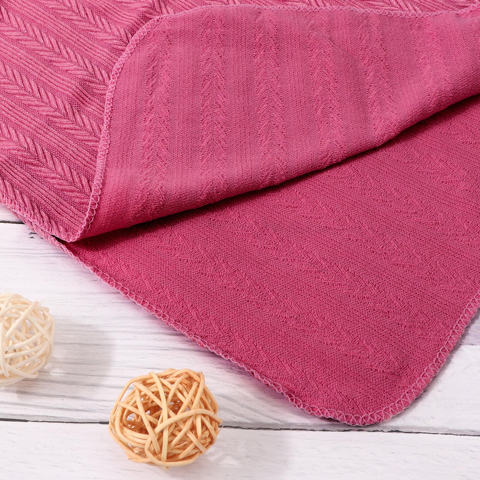 AQOKKA baby wearing swaddle showcases cozy texture and size.