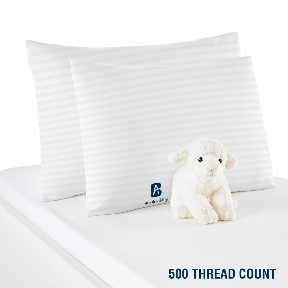 Atiksh Beddings white striped design blends with nursery decor.