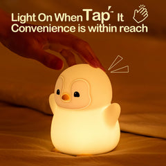 ATSUI Happy Penguin Night Light on table with touch control for easy brightness adjustment.