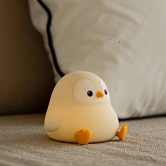 ATSUI Penguin Night Light glowing softly on a nursery shelf for bedtime comfort.