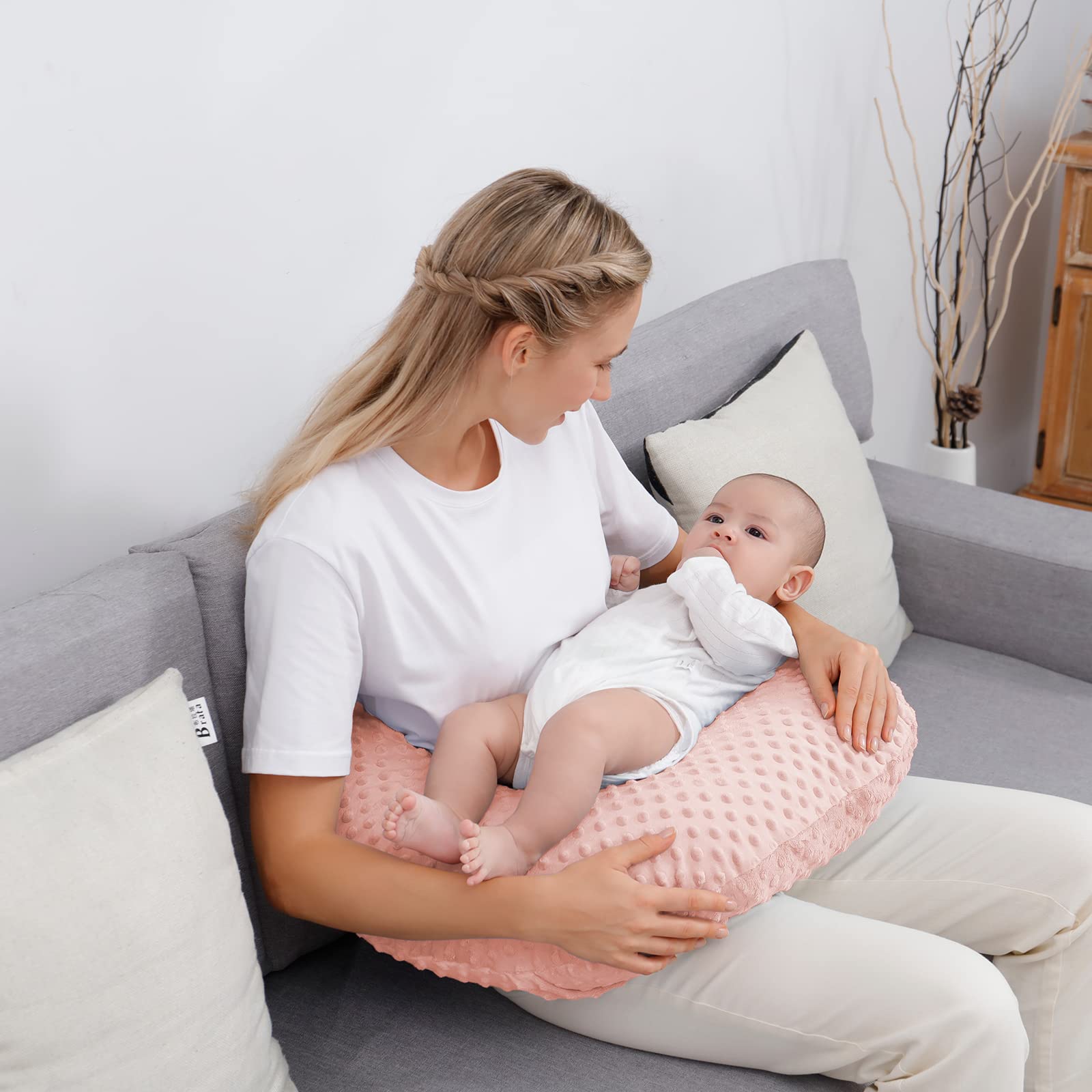 Aullar nursing pillow used for propping during awake time to ease arm strain.