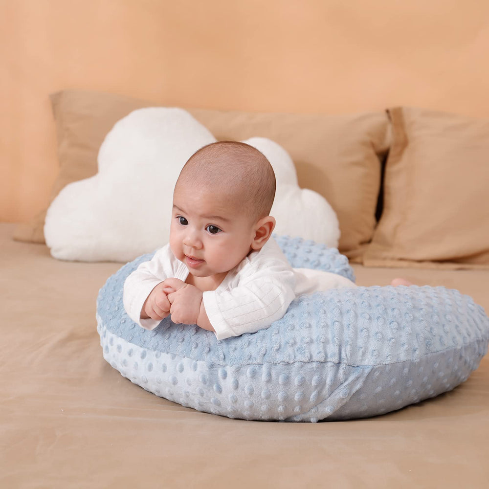 Aullar nursing pillow provides tummy time support for infant play.