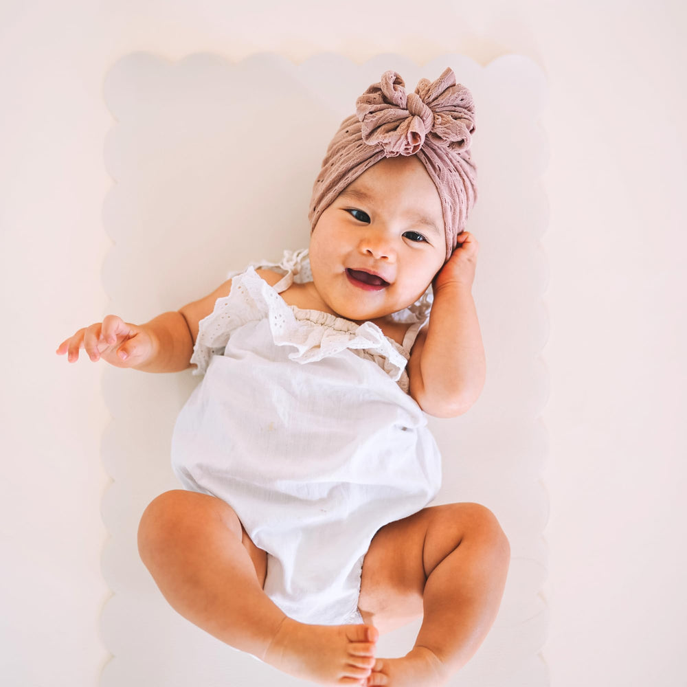 AVA + OLIVER baby changing mat in use, Sage, durable and versatile.