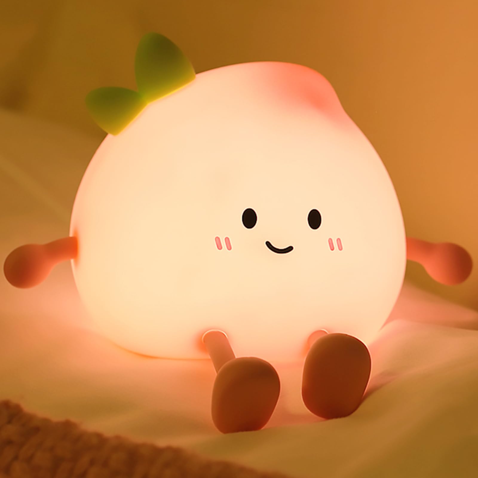 AVEKI peach night light with smiling face for cozy bedtime.