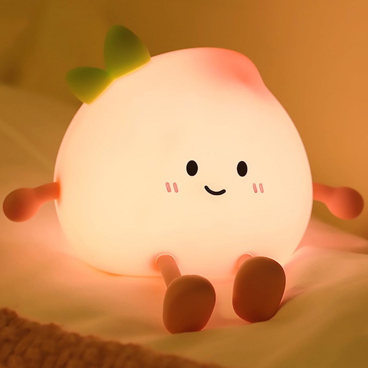 AVEKI peach night light with smiling face for cozy bedtime.