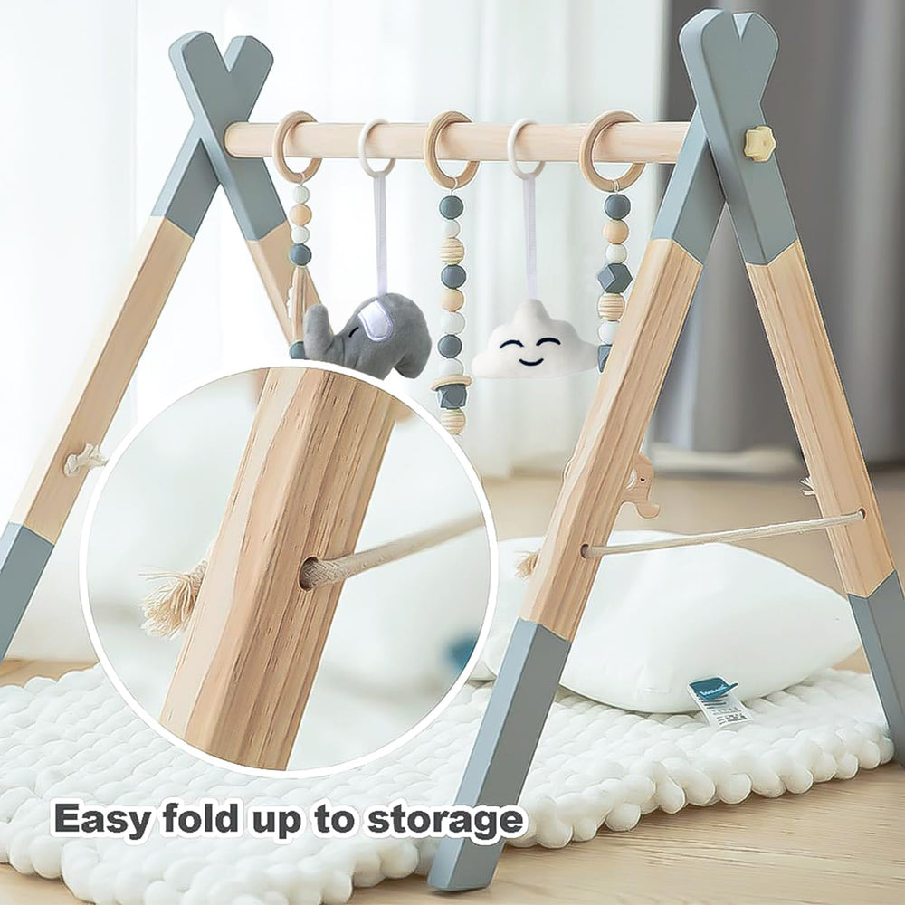 Avrsol wooden baby play gym in use with baby reaching for toys