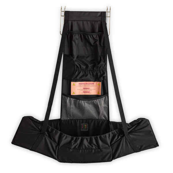 Baby Change-N-Go travel station shown over a door for private diaper changes.