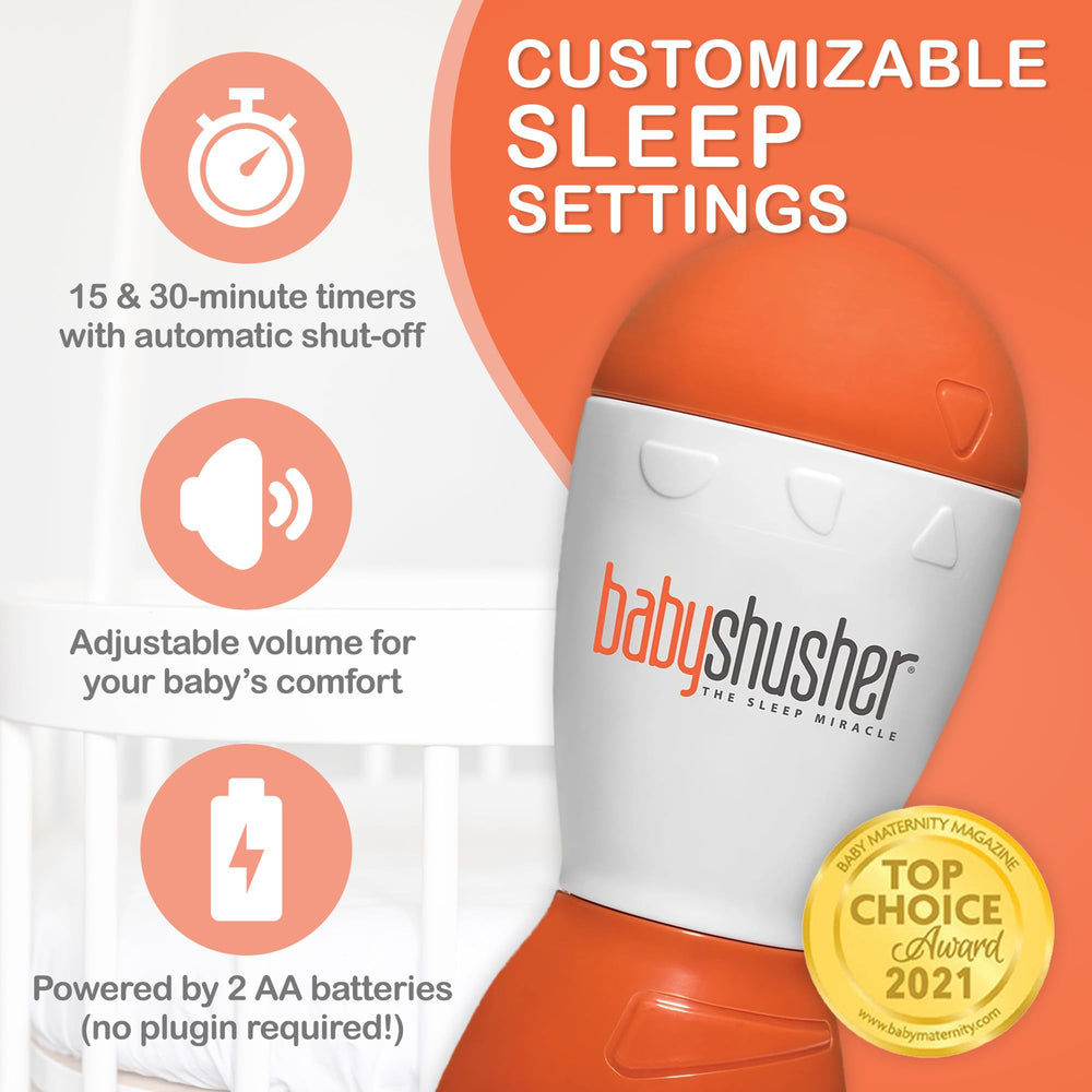 Baby sleeping in crib with Baby Shusher in use nearby for soothing.