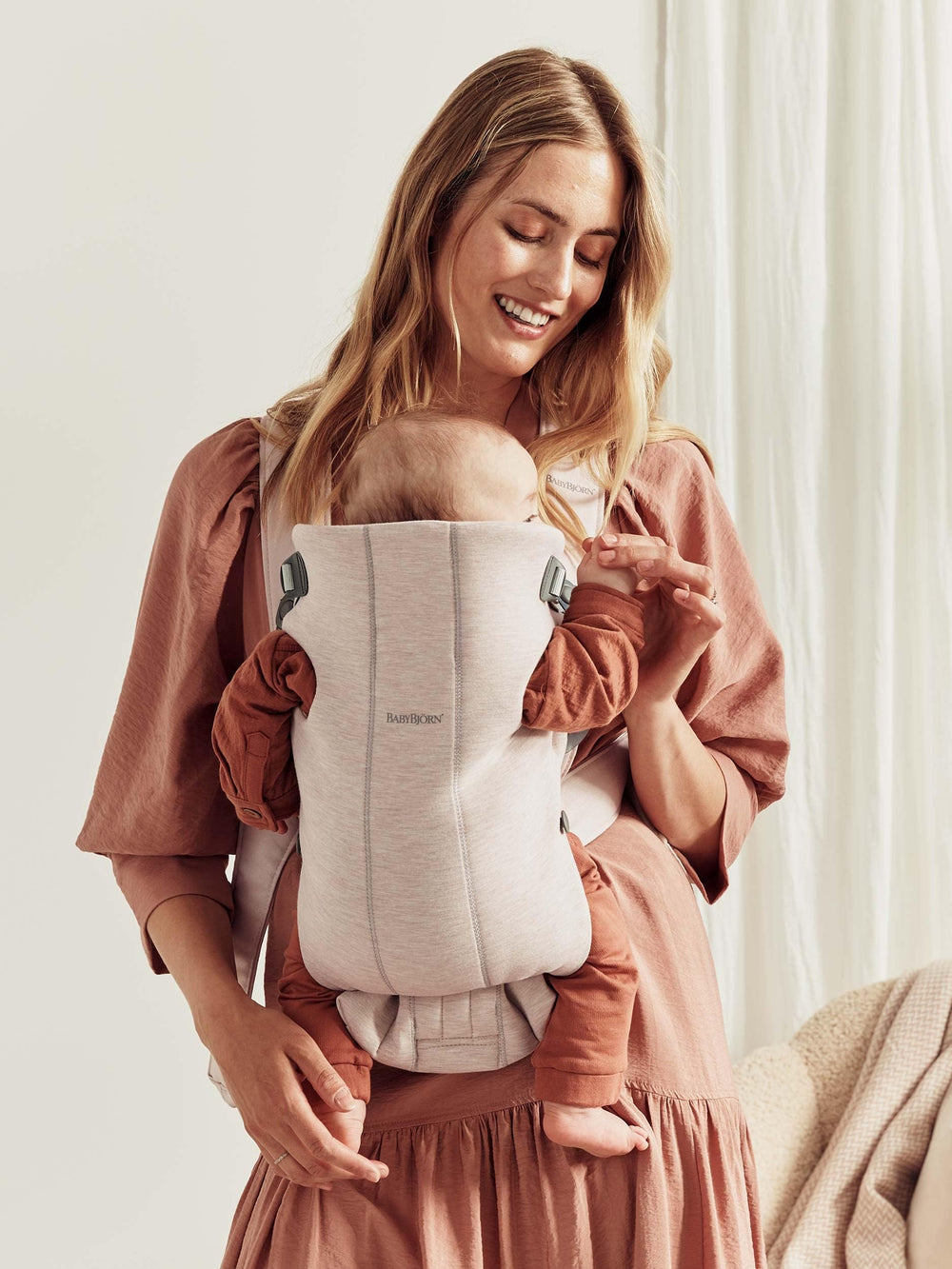Front-facing-in position on Baby Björn Carrier Mini for cozy closeness