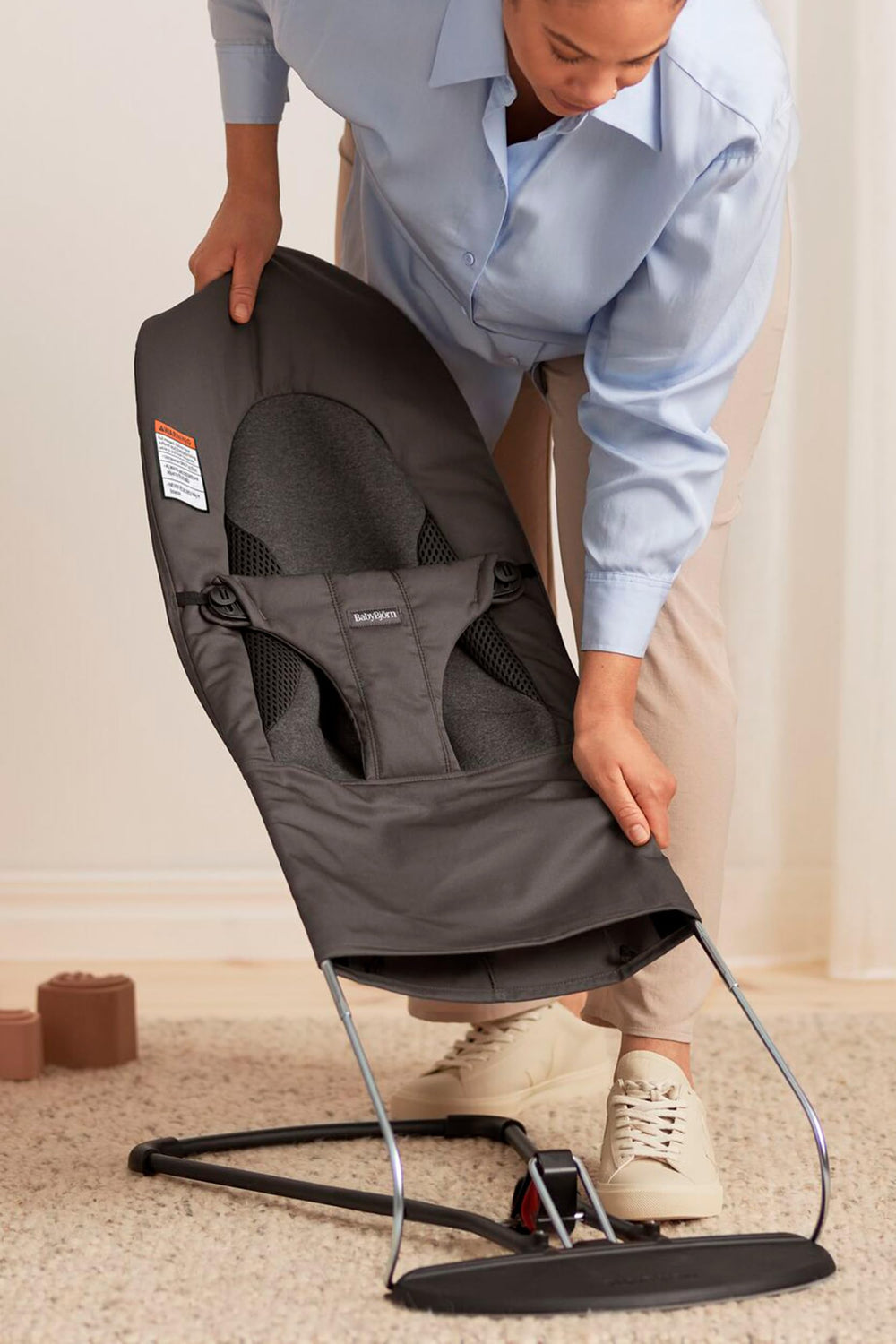 Reversible seat fabric quickly transforms the bouncer into a chair.