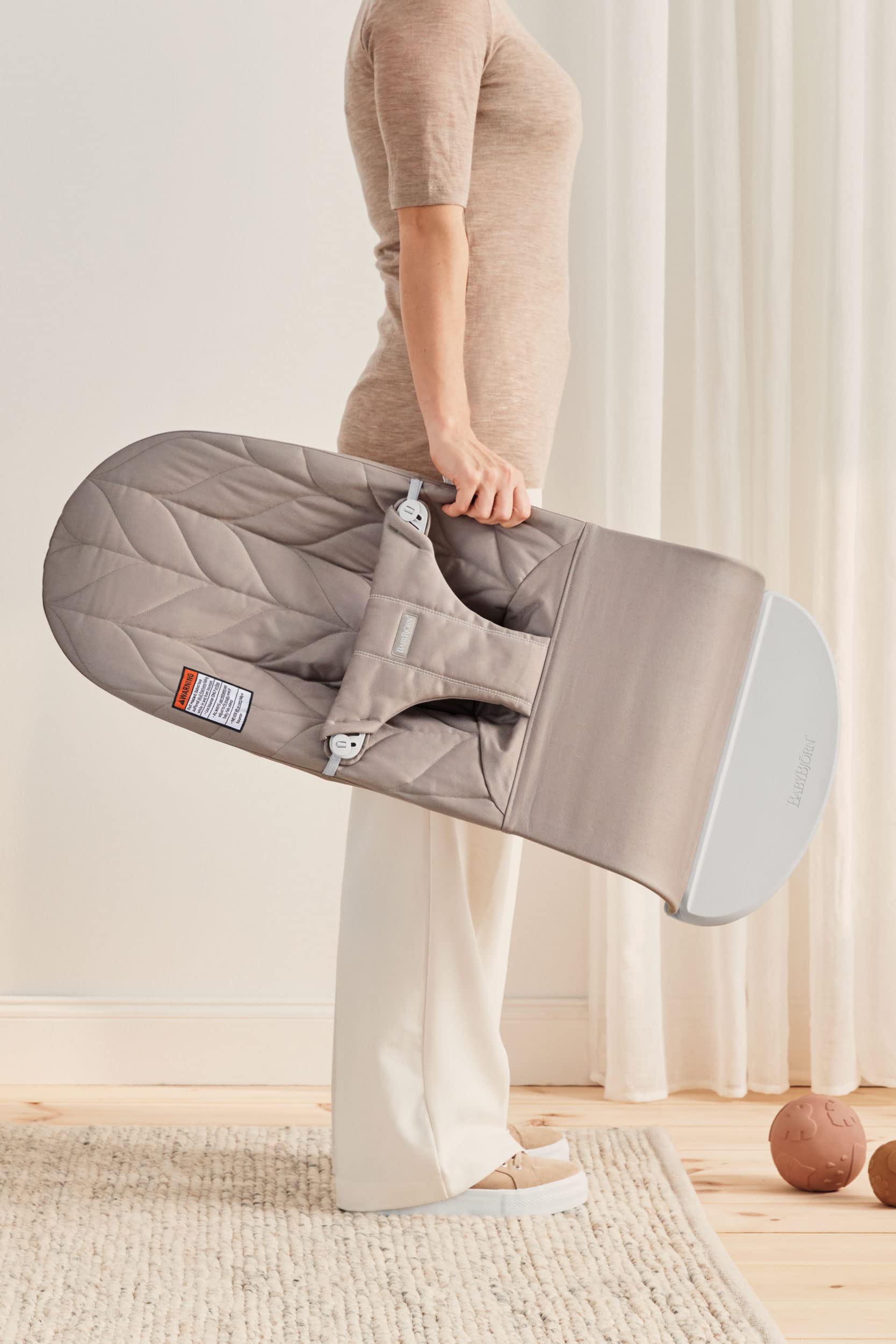 Soft sand-gray fabric close-up on BabyBjörn Bouncer Bliss for comfortable seating.