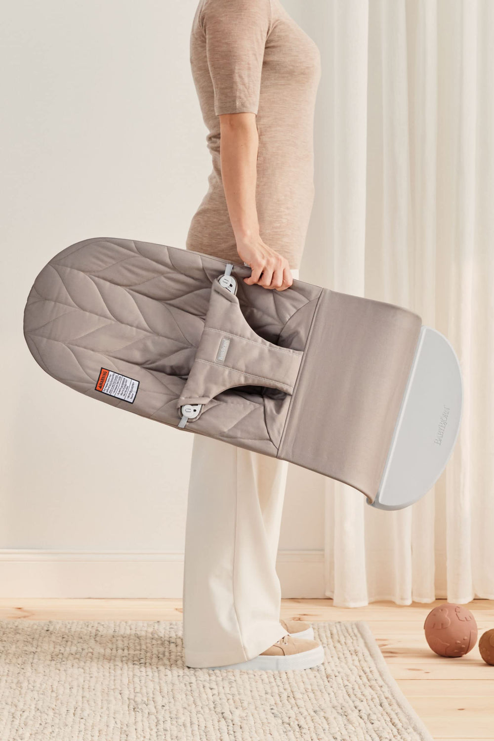 Soft sand-gray fabric close-up on BabyBjörn Bouncer Bliss for comfortable seating.