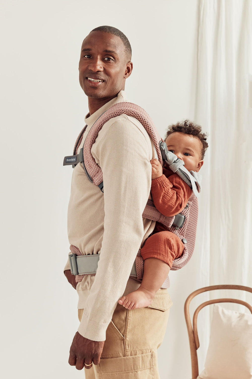 BabyBjörn Harmony back-carry pose showcases ergonomic support for caregivers