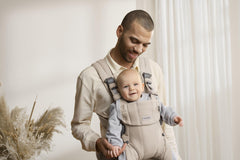 BabyBjörn Harmony front view in light beige showing ergonomic design for daily comfort