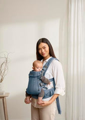 BabyBjörn Harmony shoulder strap adjustment shows comfortable wear.